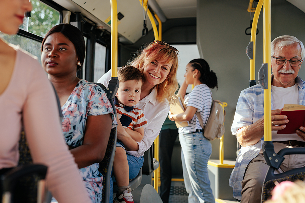 Happy mother and her son seating on the bus. 